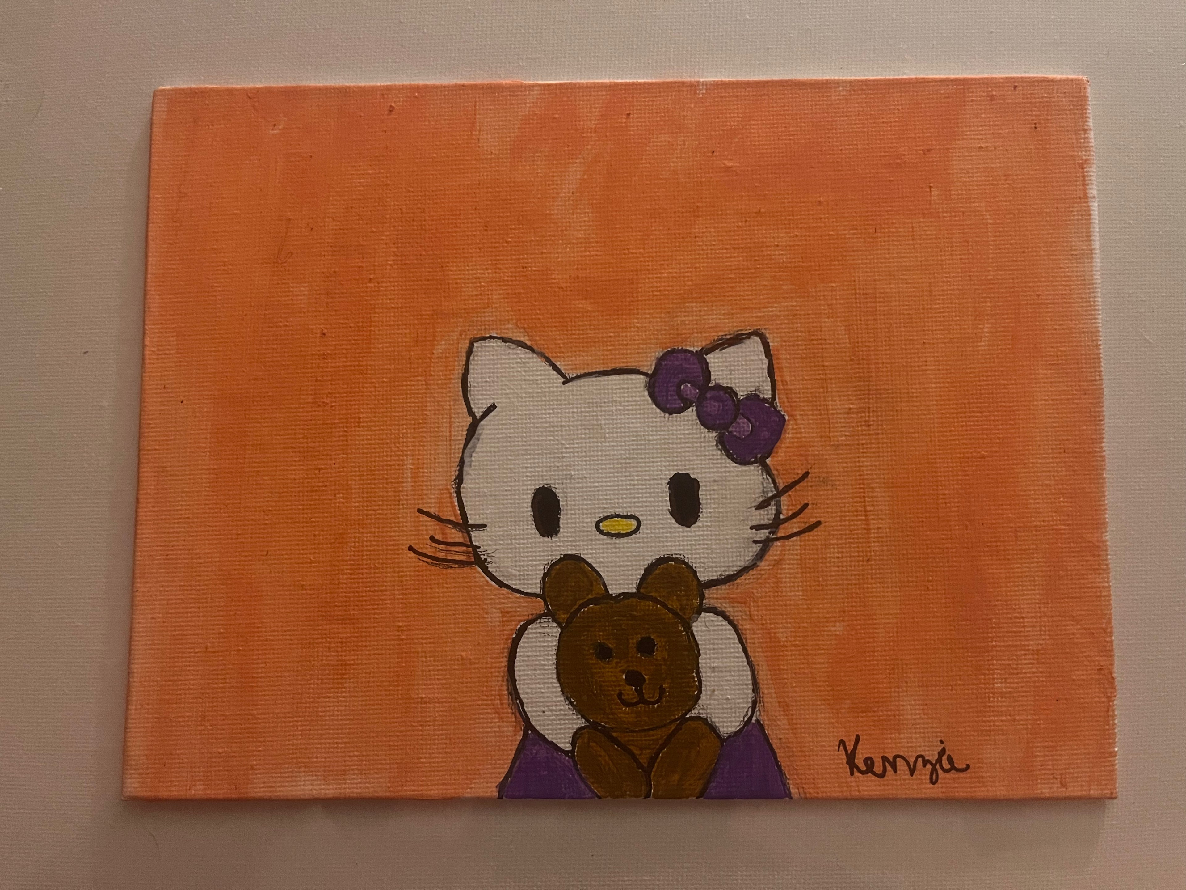 Hello kitty holding teddy bear